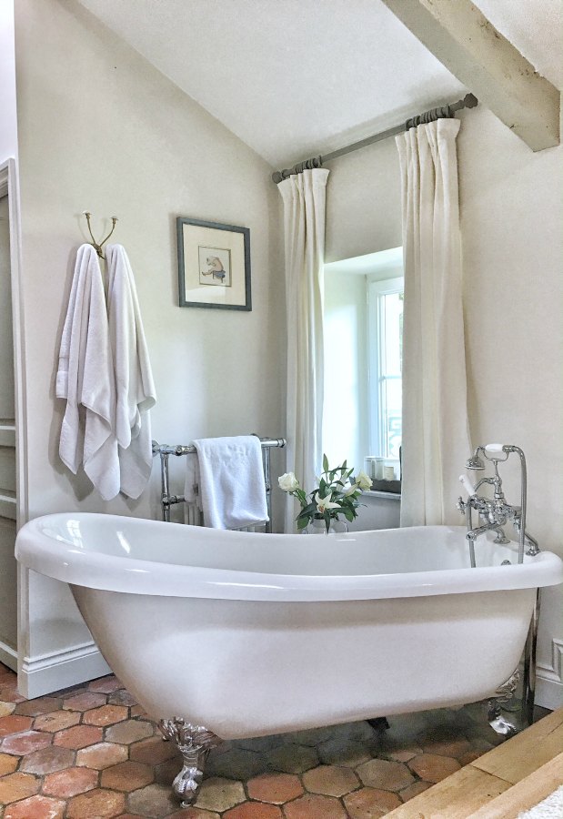 Clawfoot tub in bathroom in France. Beautiful French farmhouse design inspiration, house tour, French homewares and market baskets from Vivi et Margot. Photos by Charlotte Reiss. Come be inspired on Hello Lovely and learn the paint colors used in these beautiful authentic French country interiors. #frenchfarmhouse #hellolovelystudio #frenchcountry #designinspiration #interiordesign #housetour #vivietmargot #rusticdecor #frenchhome #authentic #farrowandballfrenchgray #frenchmarket #summerhouse #europeanfarmhouse