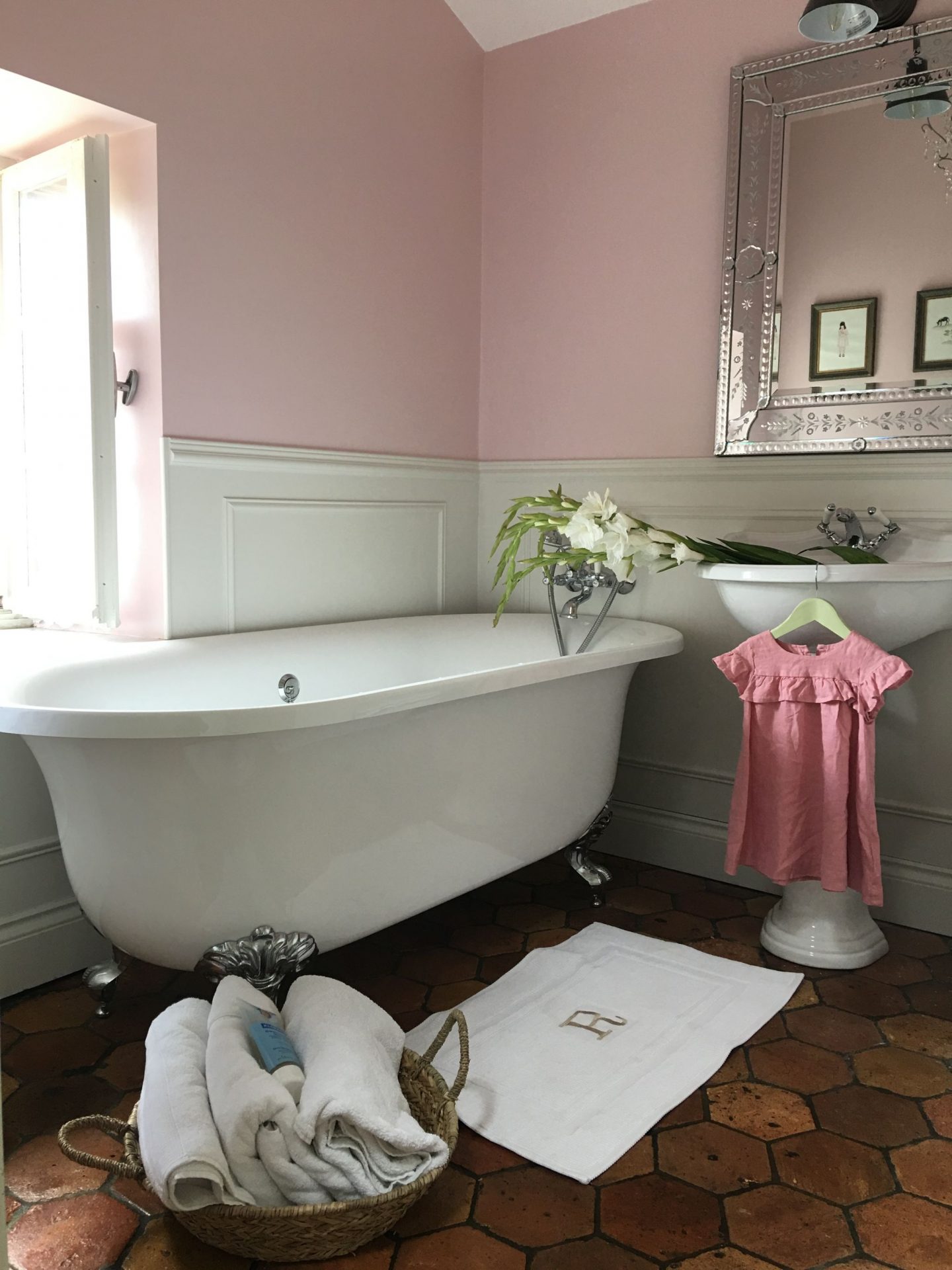 Farrow and Ball Middleton Pink paint color on the walls, a clawfoot tub, and a pedestal sink grace this French farmhouse bathroom with reclaimed terracotta hex tiles - Vivi et Margot.