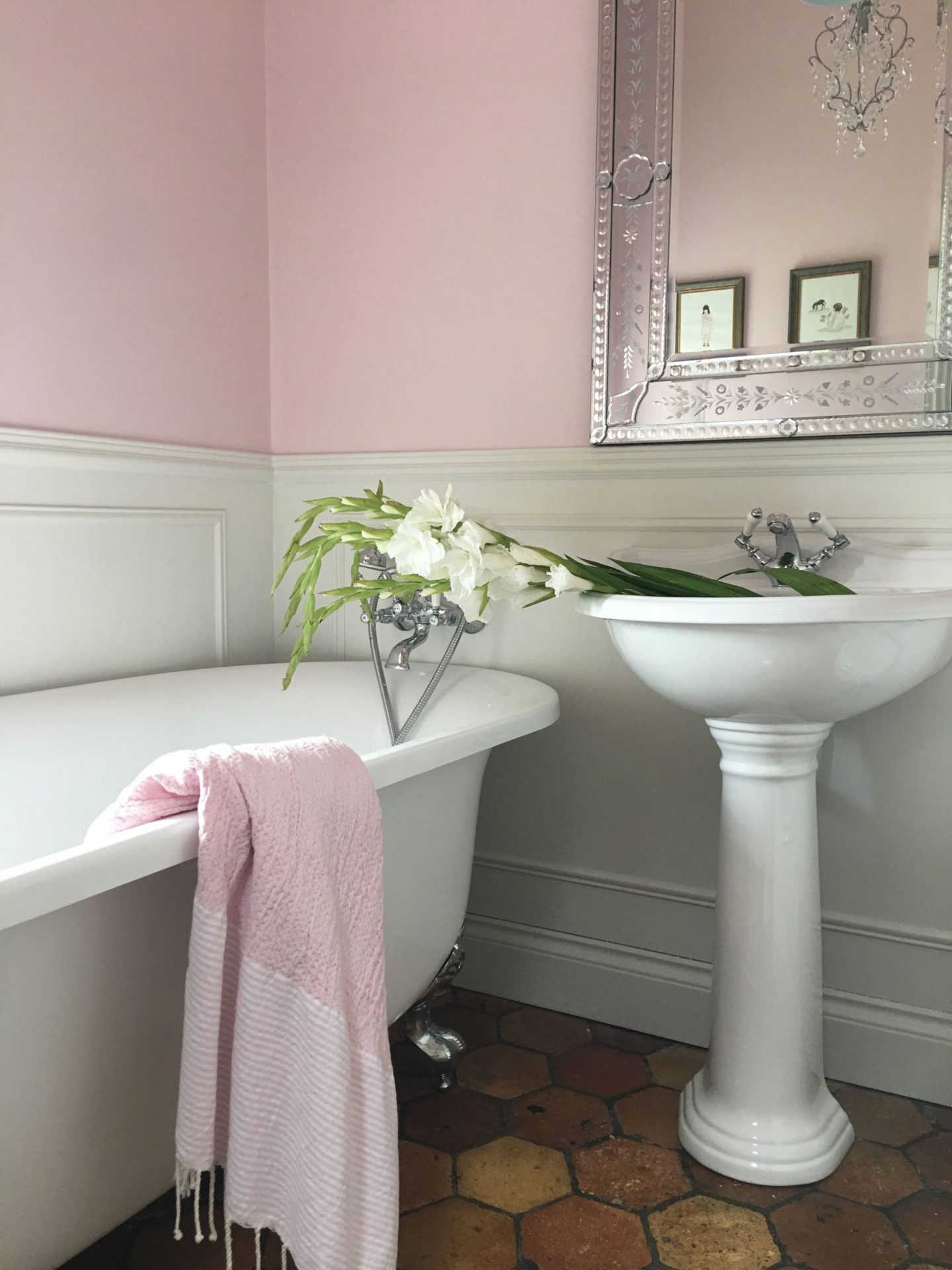 Farrow and Ball Middleton Pink paint color on the walls, a clawfoot tub, and a pedestal sink grace this French farmhouse bathroom with reclaimed terracotta hex tiles - Vivi et Margot.