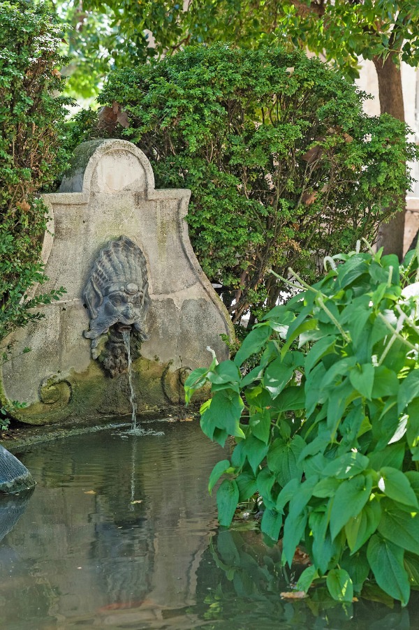 French formal gardens and old stone fountain - see more of this Stunning French Château Near St-Rémy-de-Provence by Haven In. #frenchgarden #fountains #frenchchateau