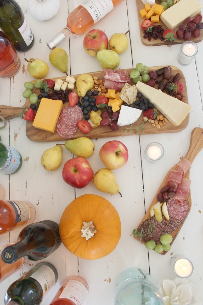 Serene fall tablescape with fruit, cheese, and wine. Hello Lovely Studio. #hellolovelystudio #tablescape #falltablescape #cheeseboard #serene #farmhousetable