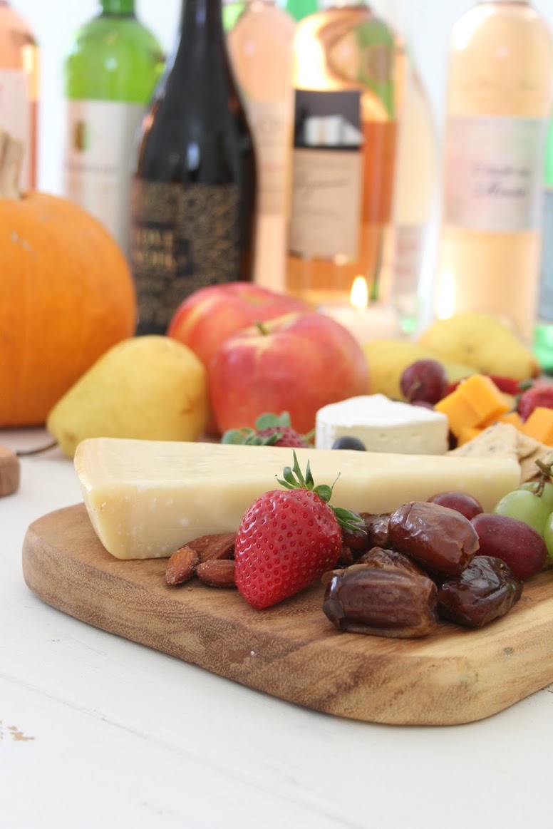 Colorful fruit and cheese for a fall tablescape. Hello Lovely Studio. #hellolovelystudio #cheeseboard #falltablescape #wineandcheese