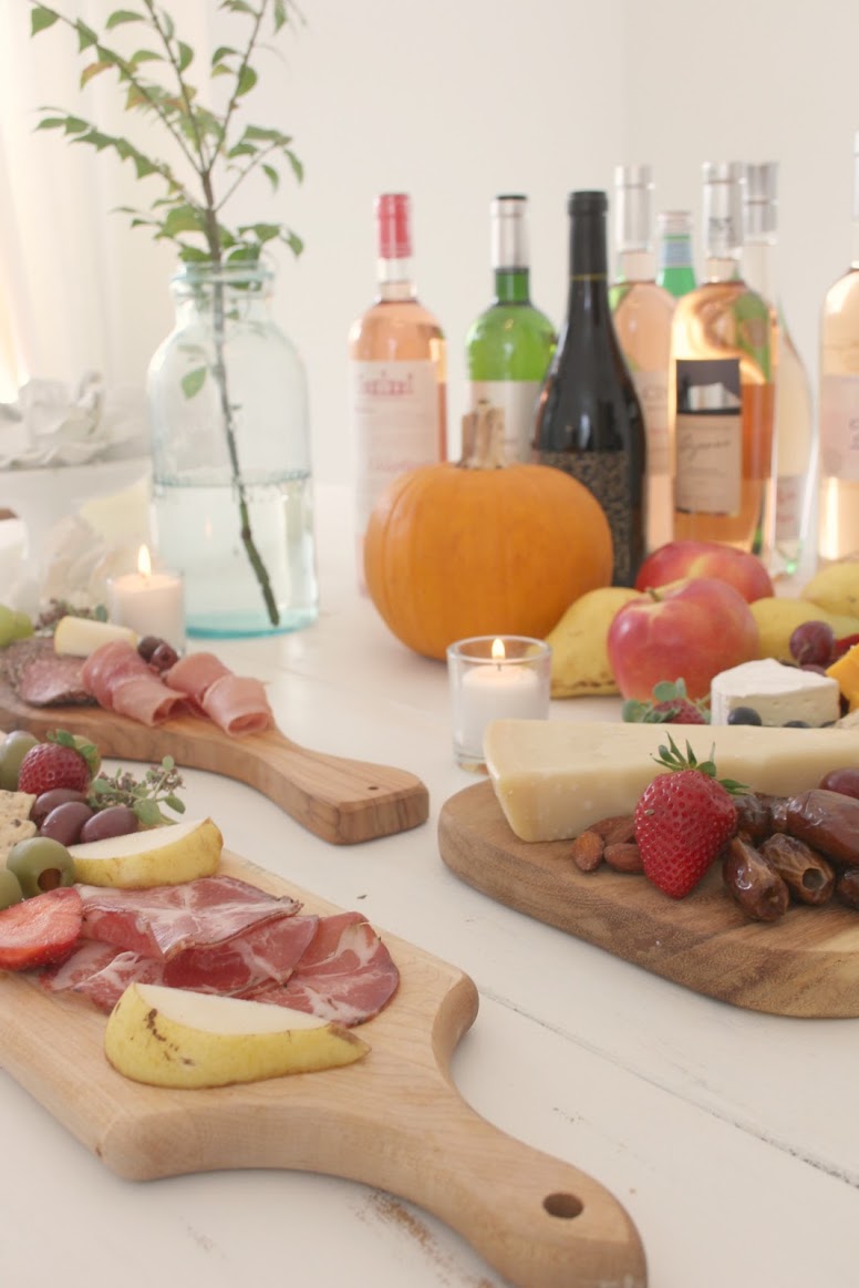 Serene tablescape with cheese boards, charcuterie, and wine by Hello Lovely Studio. #hellolovelystudio #cheeseboard #charcuterie #tablescape #falltablescape