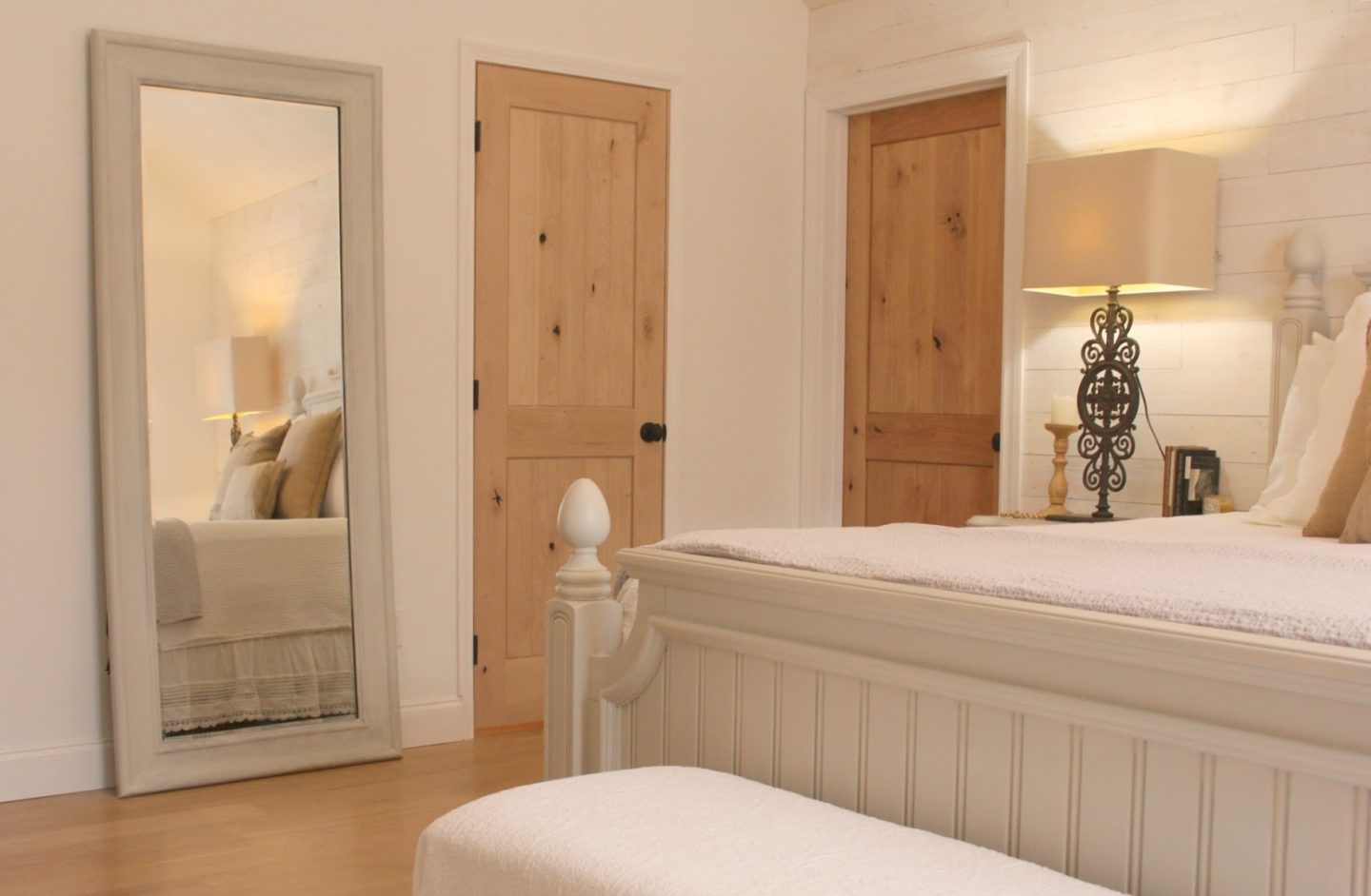 Nordic French white bedroom with light grey, linen, and white. Stikwood on wall, alder doors, cottage style furniture, and white oak flooring. #hellolovelystudio #bedroom #frenchcountry #nordicfrench #stikwood #serene #romantic #whitebedroom