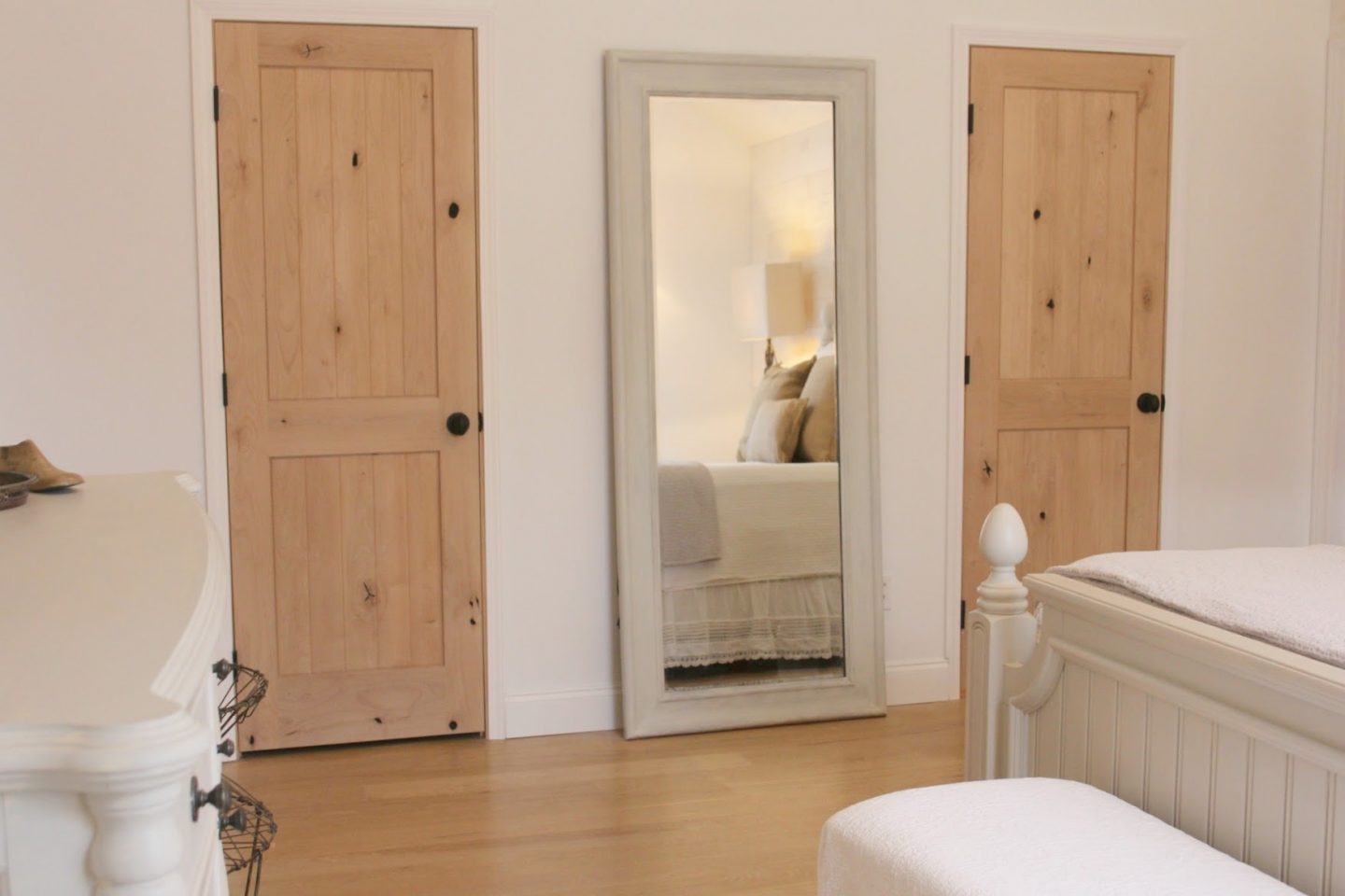 Nordic French white bedroom with light grey, linen, and white. Stikwood on wall, alder doors, cottage style furniture, and white oak flooring. #hellolovelystudio #bedroom #frenchcountry #nordicfrench #stikwood #serene #romantic #whitebedroom