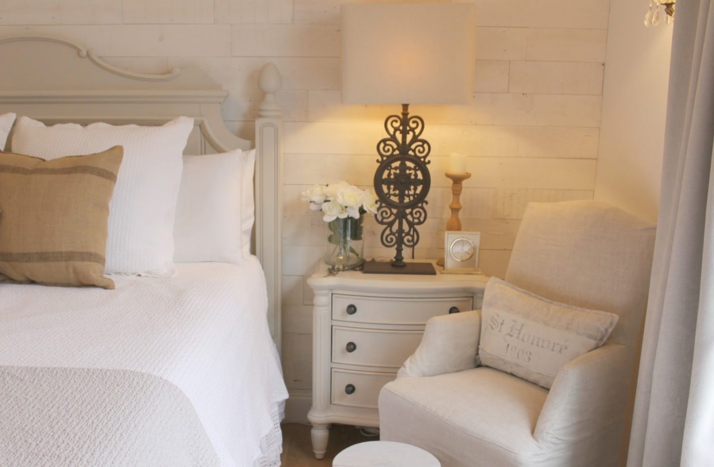 Nordic French white bedroom with light grey, linen, and white. Stikwood on wall, alder doors, cottage style furniture, and white oak flooring. #hellolovelystudio #bedroom #frenchcountry #nordicfrench #stikwood #serene #romantic #whitebedroom