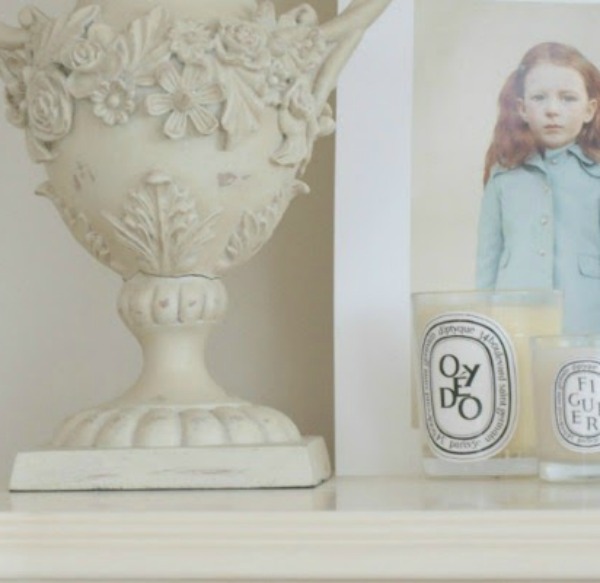 Serene vignette on a dresser with urn, candles, and painting by Loretta Lux. #hellolovelystudio #serenedecor #whitedecor