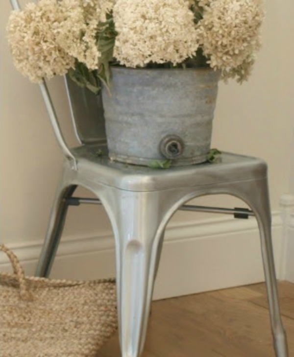 Hydrangea in a vintage bucket upon a French metal chair. Hello Lovely Studio. #shabbychic #hydrangea #frenchfarmhouse #hellolovelystudio