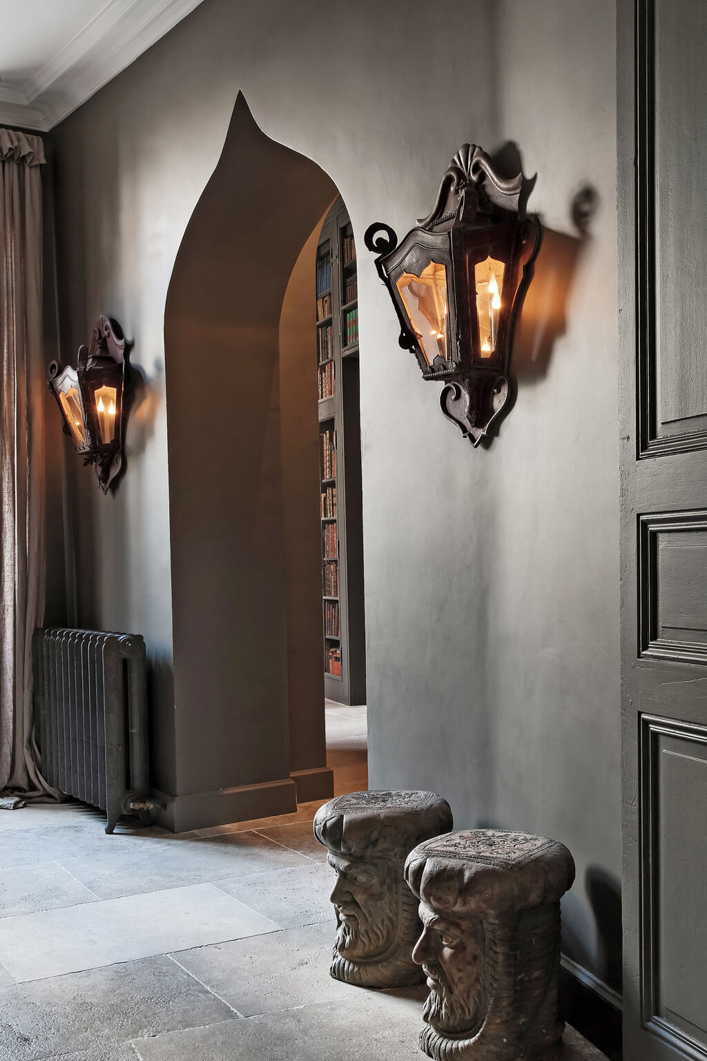 Deep and dark, French gray walls add drama in an Avignon mansion's hall. Come see a Breathtaking French Château Tour in Provence With Photo Gallery of Historical Architecture, Dramatic Eclectic Interiors & Oddities!