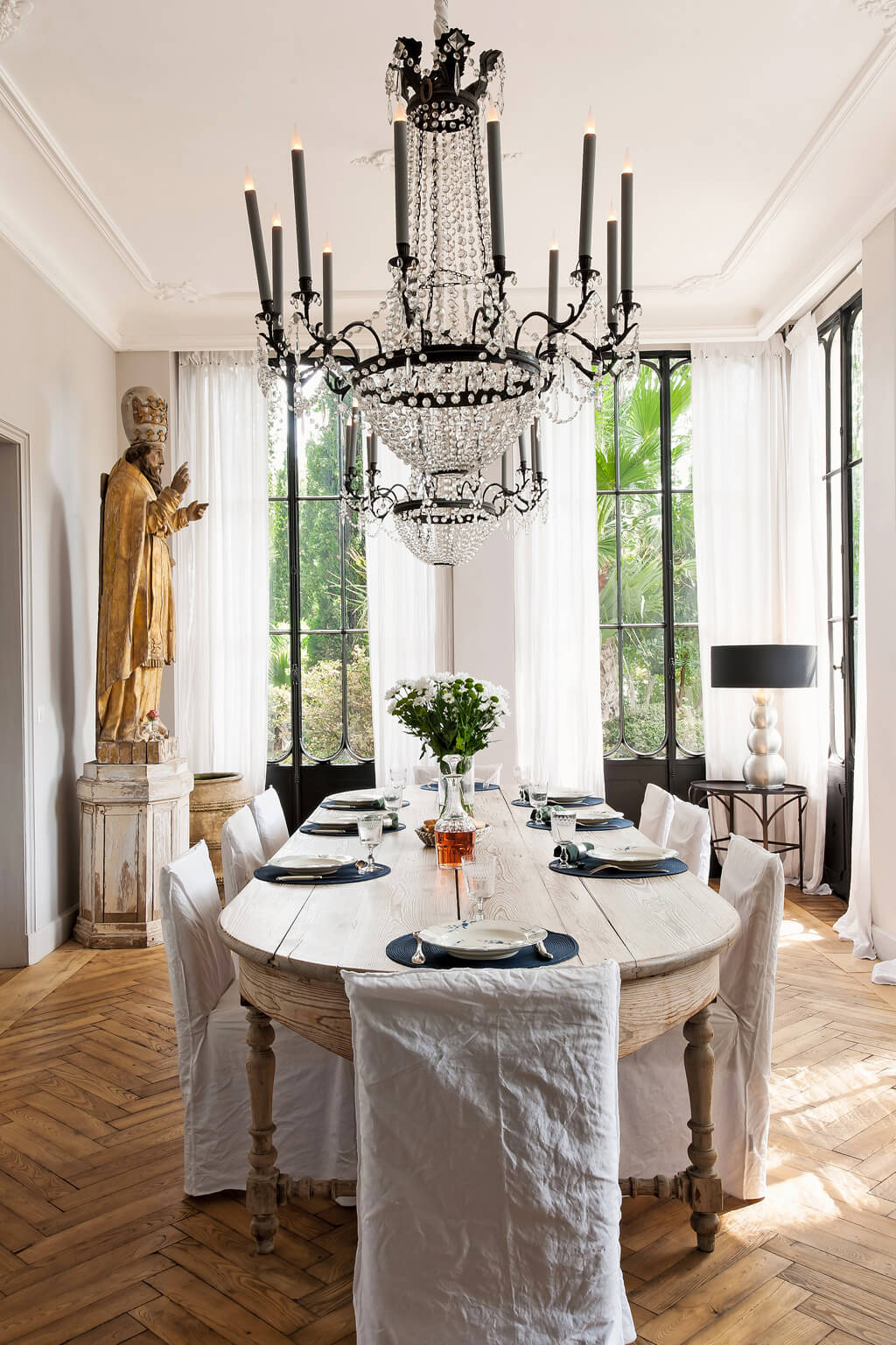 Ethereal and rustic Avignon dining room with Empire chandeliers. Come see a Breathtaking French Château Tour in Provence With Photo Gallery of Historical Architecture, Dramatic Eclectic Interiors & Oddities!