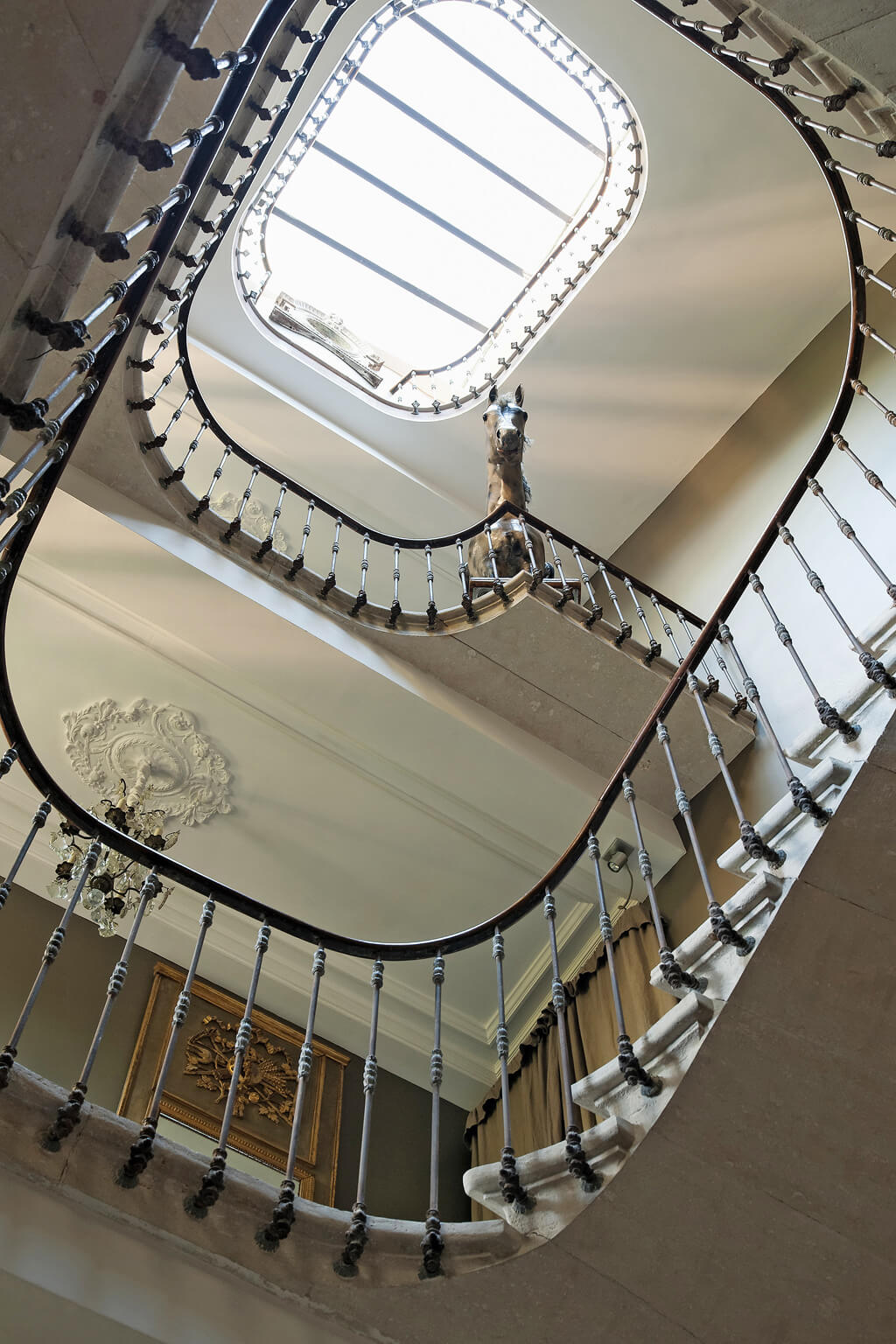 Magnificent French iron staircase. Come see a Breathtaking French Château Tour in Provence With Photo Gallery of Historical Architecture, Dramatic Eclectic Interiors & Oddities!