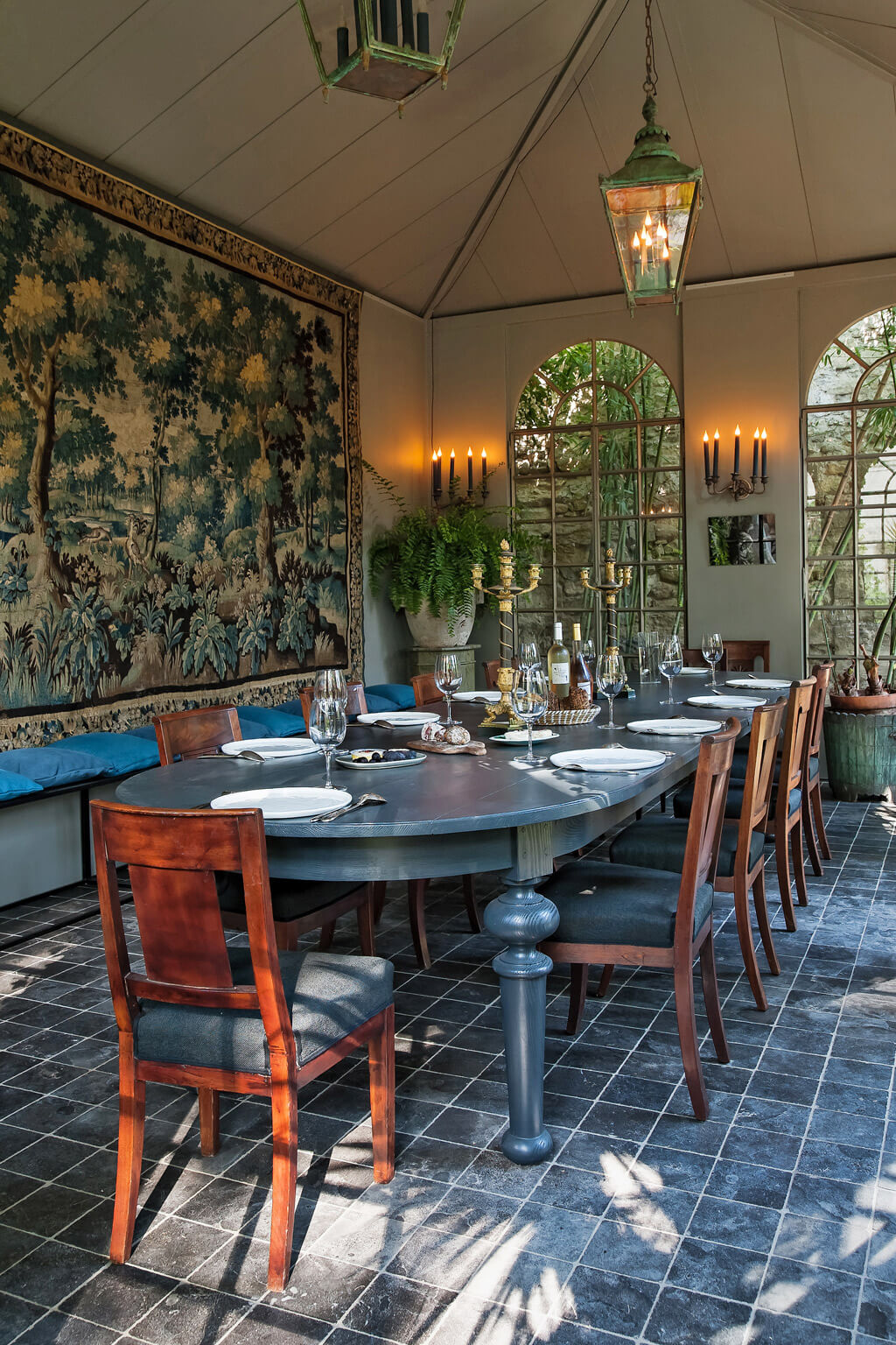 Orangerie dining room decorated with blue in Provence. Come see a Breathtaking French Château Tour in Provence With Photo Gallery of Historical Architecture, Dramatic Eclectic Interiors & Oddities!