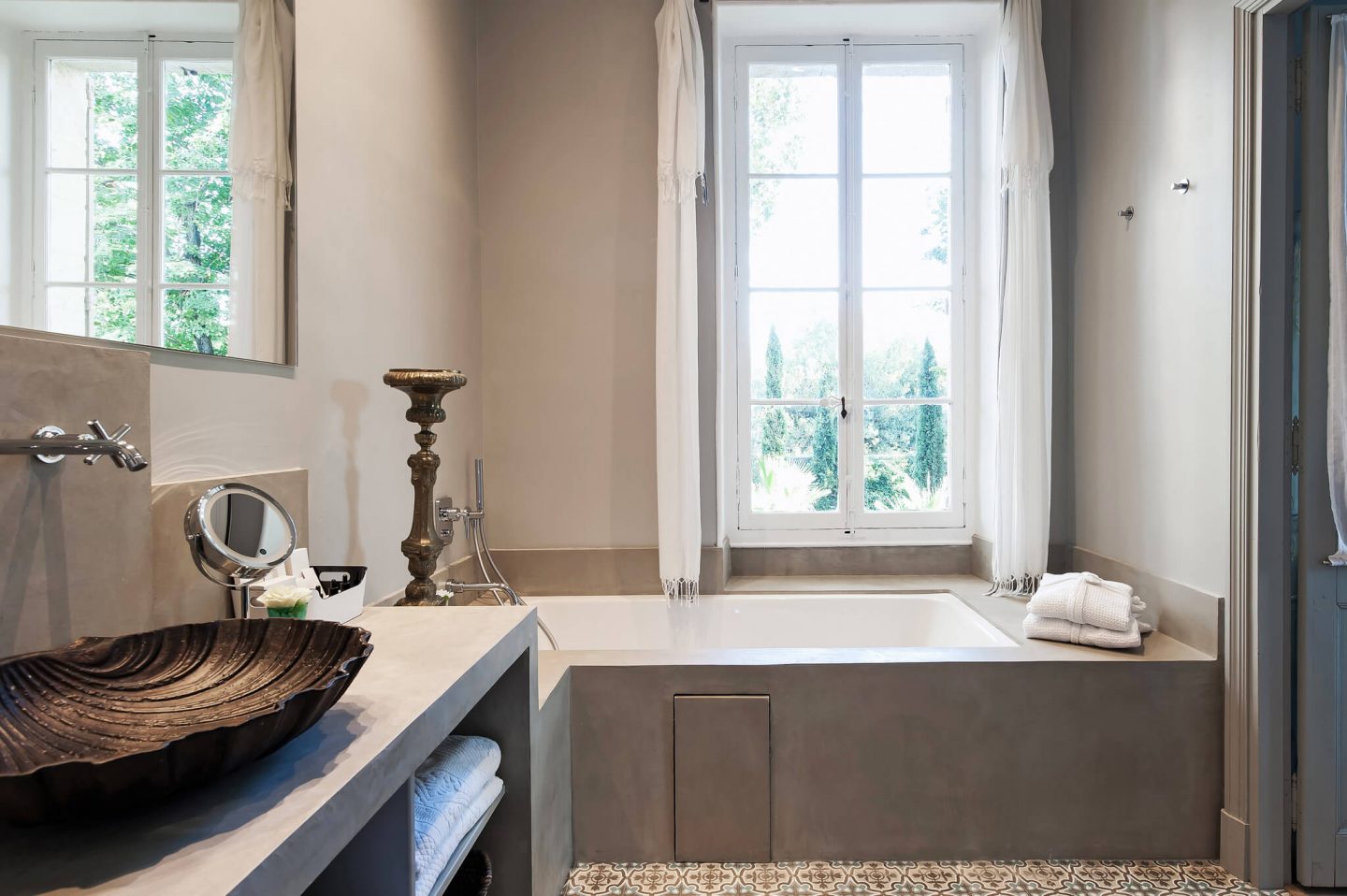 Unique vessel sink in a serene and spare modern French bathroom. Serene French Country Style interior design inspiration. The Serenity Suite at Avignon Hôtel Particulier. Luxurious and timeless restored 19th century French chateau in the South of France. Provencal romance, traditional architecture, modern French design, unique art, and European antiques. Photo: Haven In.