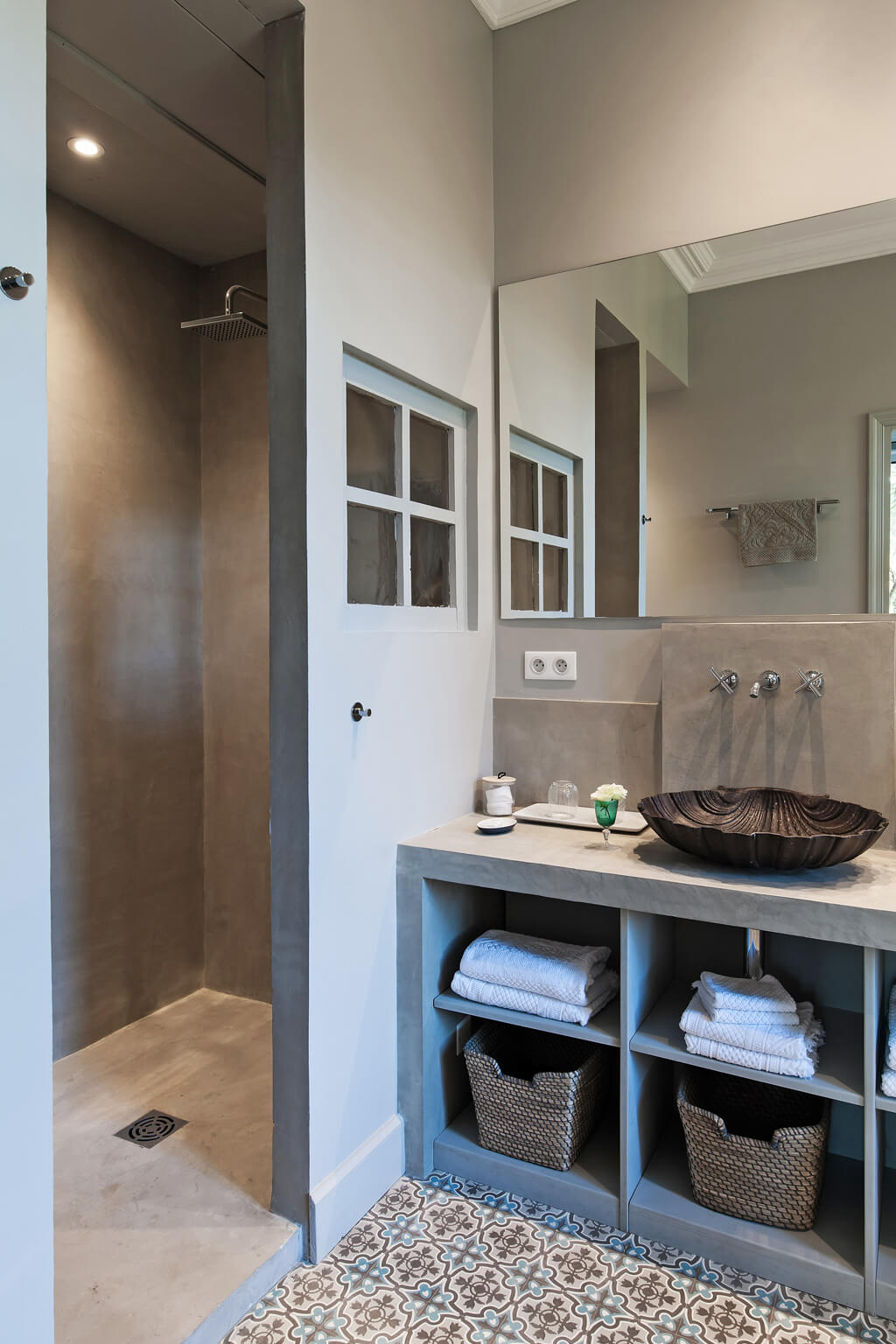 Open cubes in bathroom vanity and a minimal modern shower. Serene French Country Style interior design inspiration. The Serenity Suite at Avignon Hôtel Particulier. Luxurious and timeless restored 19th century French chateau in the South of France. Provencal romance, traditional architecture, modern French design, unique art, and European antiques. Photo: Haven In.