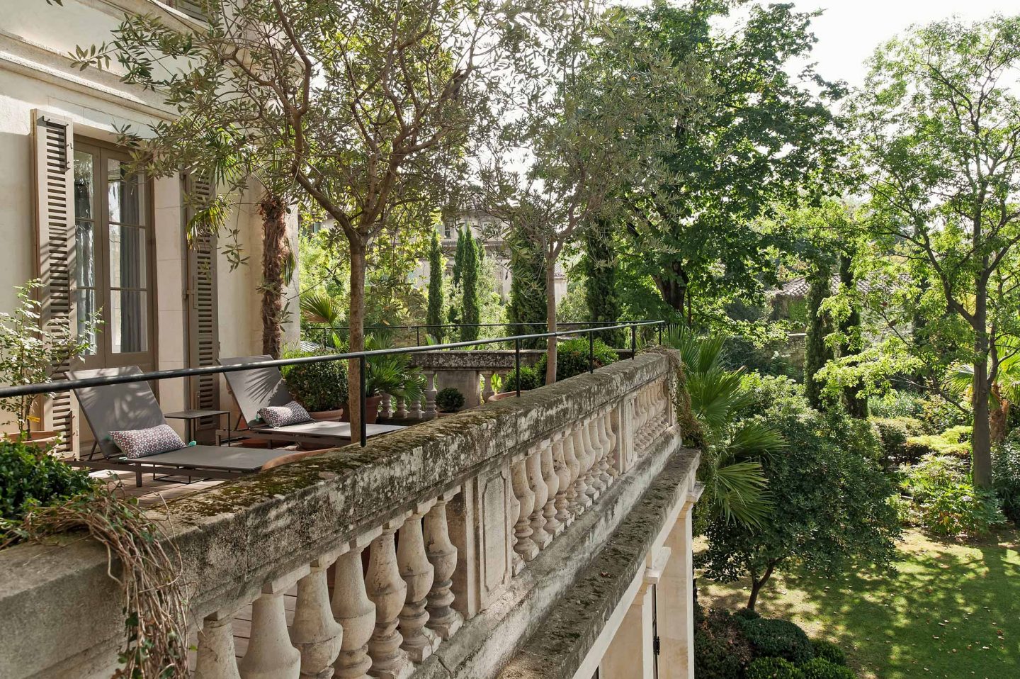 Magnificent facade of a balcony on a French chateau. Serene French Country Style interior design inspiration. The Serenity Suite at Avignon Hôtel Particulier. Luxurious and timeless restored 19th century French chateau in the South of France. Provencal romance, traditional architecture, modern French design, unique art, and European antiques. Photo: Haven In.