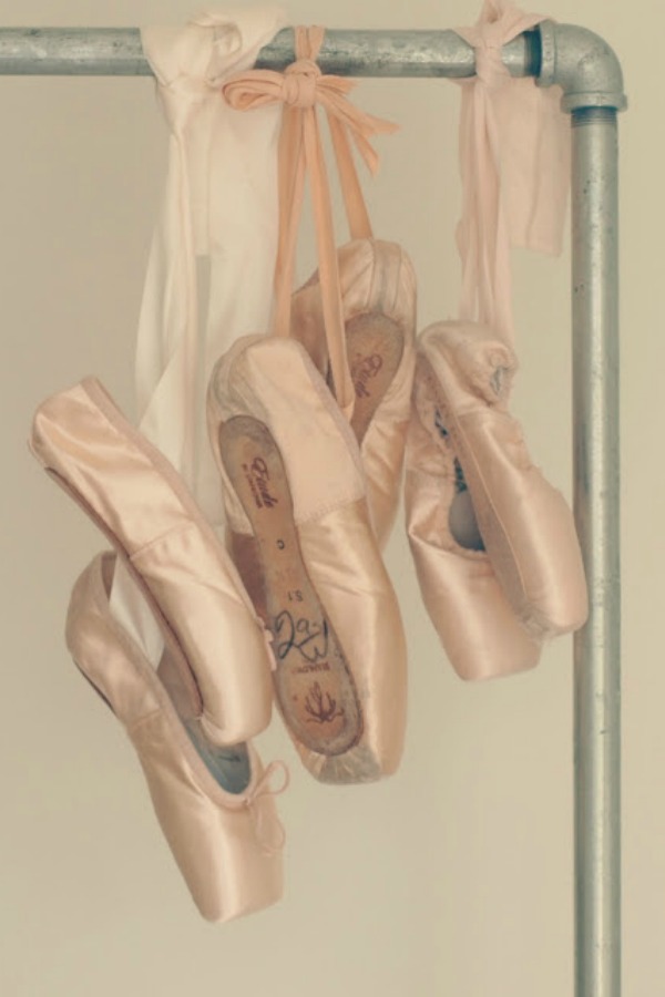 Pink ballet slippers (pointe shoes) hung from an industrial garment rack by Hello Lovely Studio. #balletslippers #ballerina #pointeshoes #hellolovelystudio #romanticdecor #shabbychic