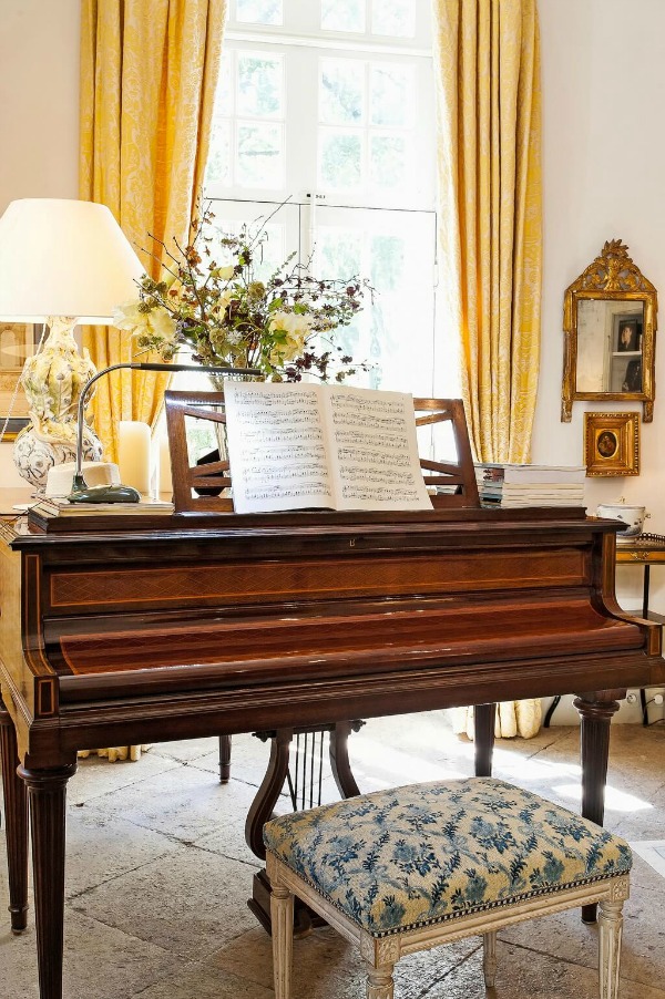 Piano in French country living room. Rustic and elegant: Provençal home, European farmhouse, French farmhouse, and French country design inspiration from Chateau Mireille. Photo: Haven In. South of France 18th century Provence Villa luxury vacation rental near St-Rémy-de-Provence.