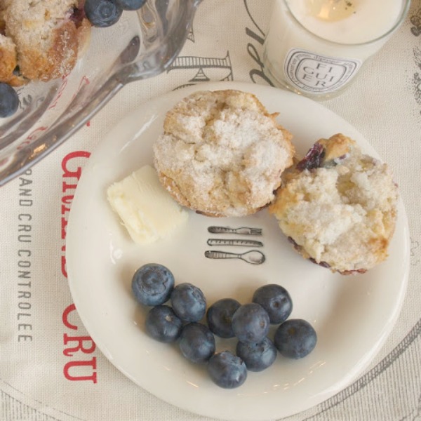 Mini coffee cakes and blueberries on a Rae Dunn plate. Hello Lovely Studio.