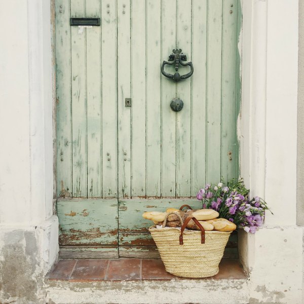 Charming weathered green door! French farmhouse design inspiration, house tour, French homewares and market baskets from Vivi et Margot. Photos by Charlotte Reiss. Come be inspired on Hello Lovely and learn the paint colors used in these beautiful authentic French country interiors. #frenchfarmhouse #hellolovelystudio #frenchcountry #designinspiration #interiordesign #housetour #vivietmargot #rusticdecor #frenchhome #authentic #frenchmarket #summerliving #bordeaux #westernfrance #europeanfarmhouse