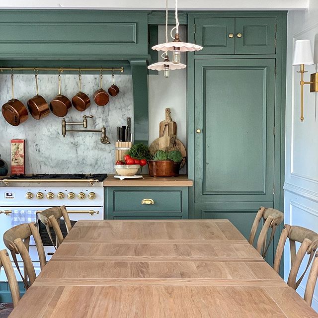 French farmhouse kitchen by Vivi et Margot has a luxurious Ilve range and cabinets painted Farrow & Ball Smoke Green. #frenchfarmhouse #frenchkitchen #kitchendesign #farrowandballsmokegreen
