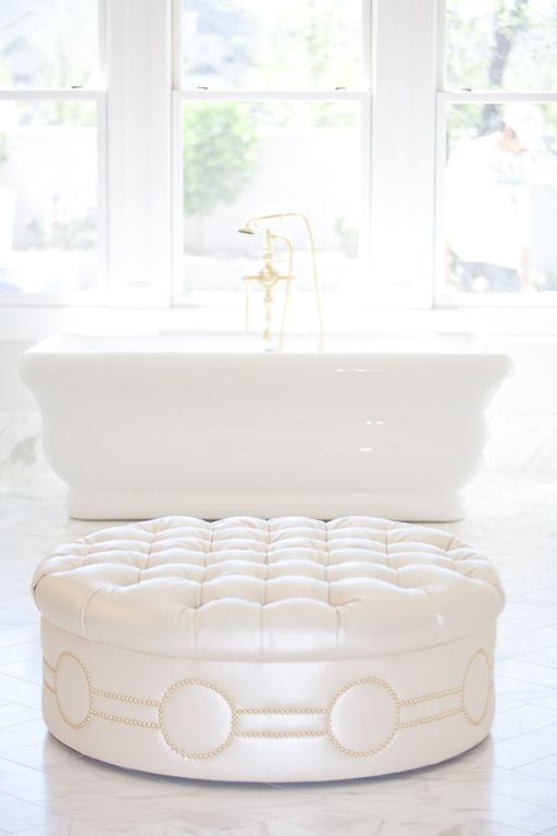 Tufted ottoman and freestanding tub in luxurious white marble bathroom. Modern Chic Home in the Southwest. E&A Builders. Pinnacle Conceptions. Jaimee Rose Interiors. #modern #French #housedesign #luxuryhome