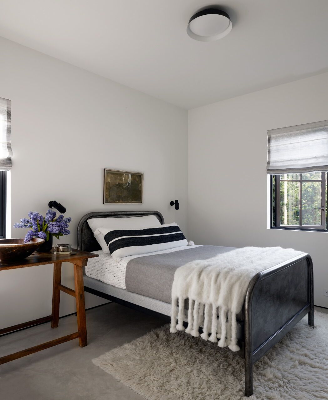 Black and white bedroom with rustic decor by Michael Del Piero.