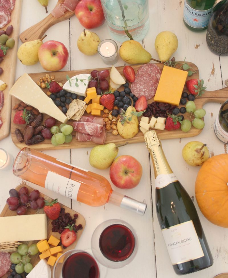 Wine and charcuterie boards on my rustic white farm table - Hello Lovely Studio.