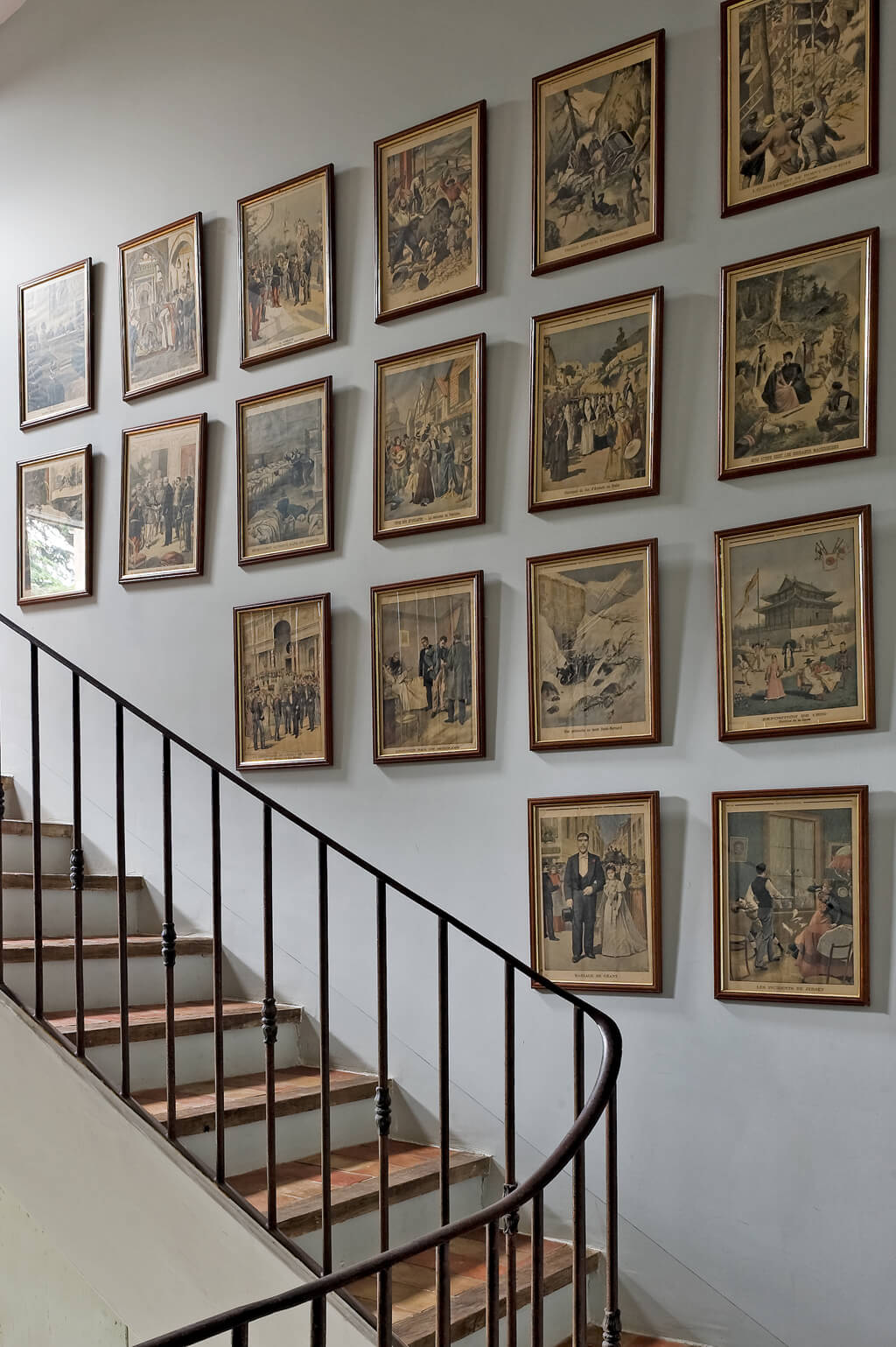 Provence country home with framed etchings massed on staircase wall. Haven In. Villa St-Saturnin. #havenin #provence #frenchcountry #interiordesign #staircase