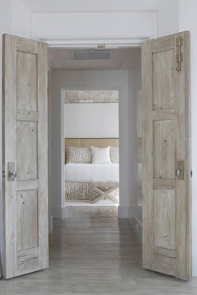 Rustic double doors open to bedroom. Stunning interior design and Timeless Architecture Inspiration: Jeffrey Dungan. Photo: William Abranowicz. #classicdesign #traditional #architecture #jeffreydungan #sophisticateddesign #architect
