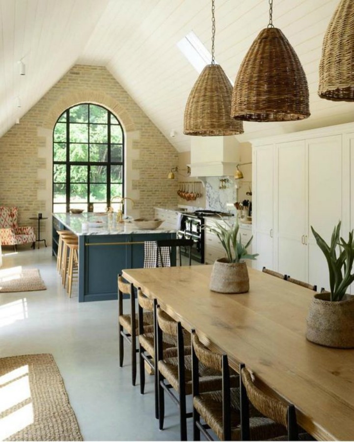 Breathtaking, elegant, and rustic luxe English country kitchen by deVOL kitchens in the UK with bespoke cabinetry, AGA stove, steel windows and doors, woven pendants, and copper accents. Interior design by Susie Atkinson.