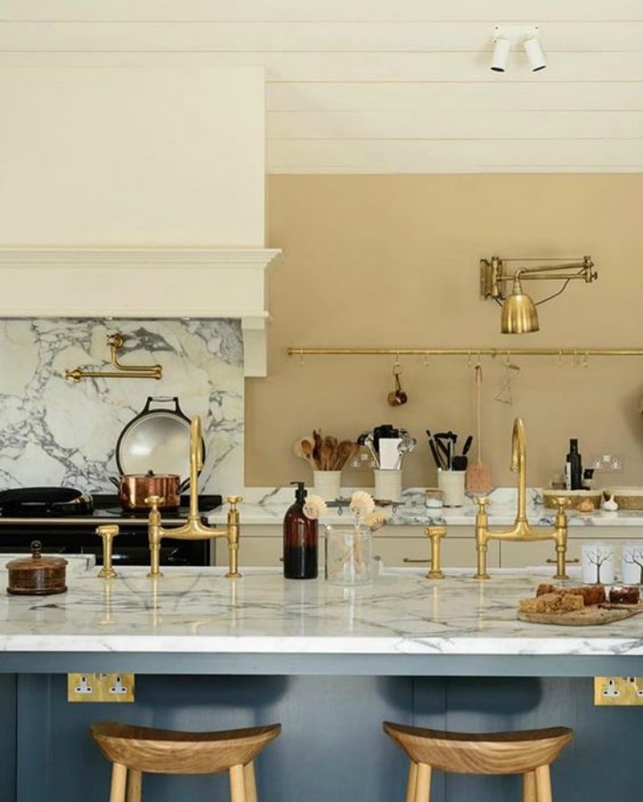 Breathtaking, elegant, and rustic luxe English country kitchen by deVOL kitchens in the UK with bespoke cabinetry, AGA stove, steel windows and doors, woven pendants, and copper accents. Interior design by Susie Atkinson.