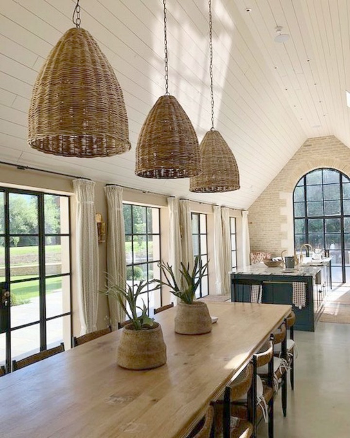 Breathtaking, elegant, and rustic luxe English country kitchen by deVOL kitchens in the UK with bespoke cabinetry, AGA stove, steel windows and doors, woven pendants, and copper accents. Interior design by Susie Atkinson.