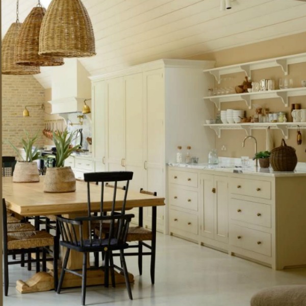 Breathtaking, elegant, and rustic luxe English country kitchen by deVOL kitchens in the UK with bespoke cabinetry, AGA stove, steel windows and doors, woven pendants, and copper accents. Interior design by Susie Atkinson.