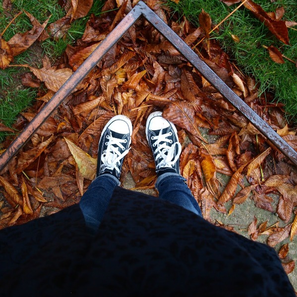 Black converse on russet red leaves in Paris. Fall leaves and inspiration for savoring the season. Visit 9 Lovely Ways to Savor Autumn Beauty for more beauty from the avenues of Paris to the American prairie. #hellolovelystudio #fallinspiration #autumn #ideas