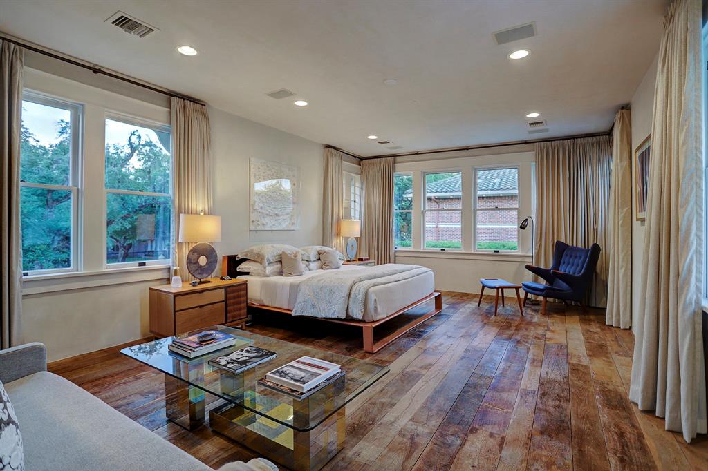 Rustic antique chestnut wood flooring in a bedroom. Luxurious interior design details in a Tudor Revival house renovation in Houston. Design consultant: Pam Pierce. Many reclaimed antique materials from Chateau Domingue. #housetour #oldworld #pampierce #chateaudomingue #europeanantiques #luxurioushome #interiordesignideas #Frenchcountry #limestone #reclaimedflooring #bespoke #houstonhome