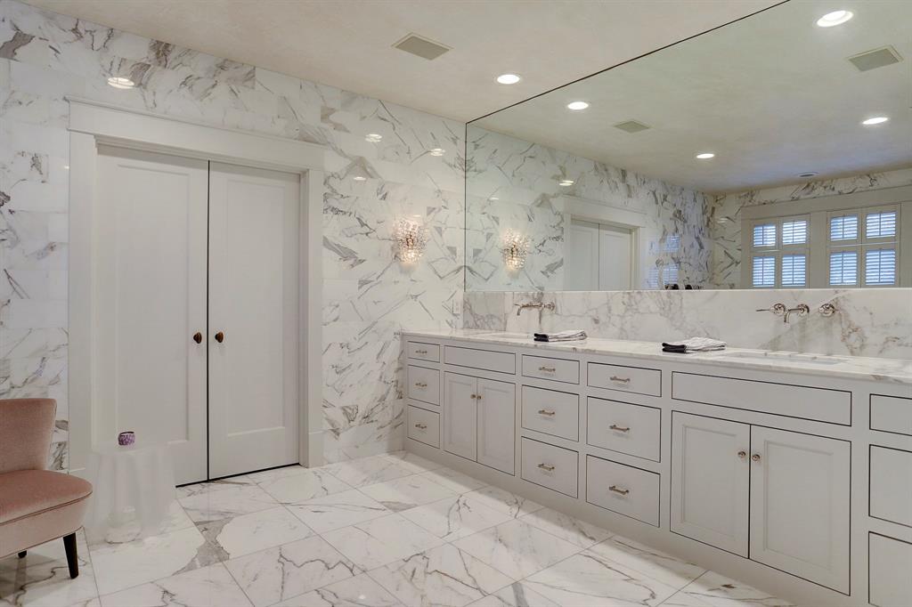 White marble bathroom.Luxurious interior design details in a Tudor Revival house renovation in Houston. Design consultant: Pam Pierce. Many reclaimed antique materials from Chateau Domingue. #housetour #oldworld #pampierce #chateaudomingue #europeanantiques #luxurioushome #interiordesignideas #Frenchcountry #limestone #reclaimedflooring #bespoke #houstonhome