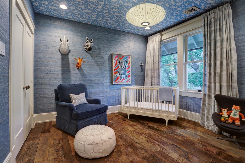 Blue seagrass wallpaper in a bedroom. Luxurious interior design details in a Tudor Revival house renovation in Houston. Design consultant: Pam Pierce. Many reclaimed antique materials from Chateau Domingue. #housetour #oldworld #pampierce #chateaudomingue #europeanantiques #luxurioushome #interiordesignideas #Frenchcountry #limestone #reclaimedflooring #bespoke #houstonhome