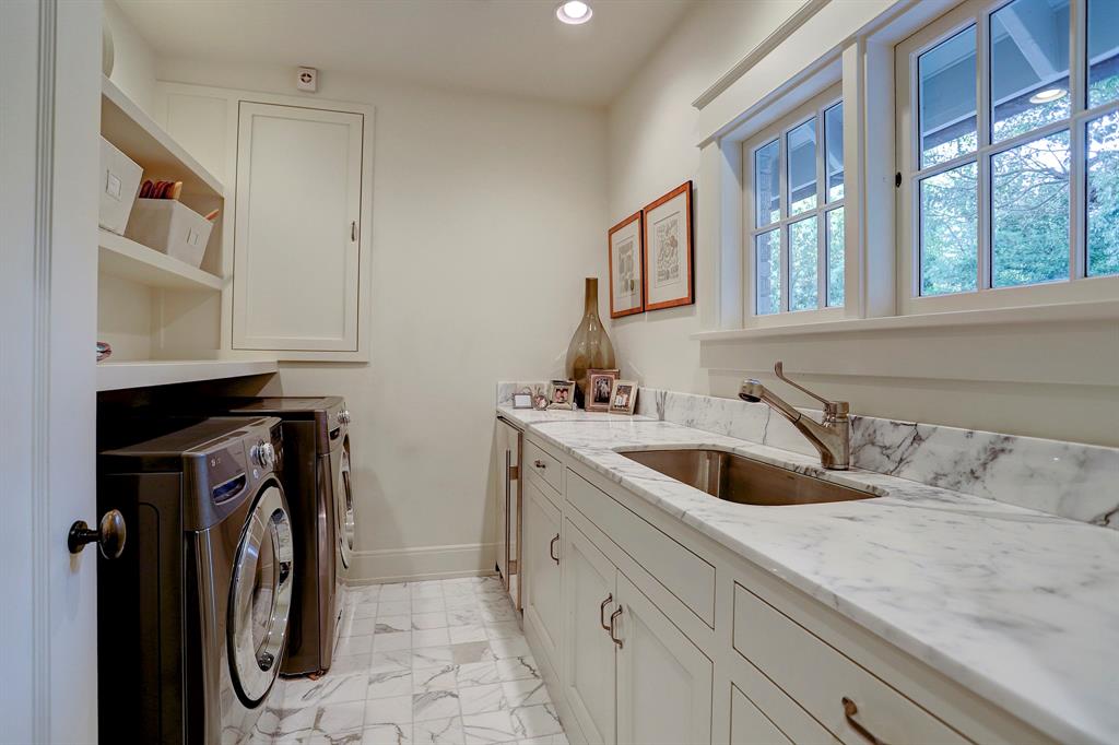 Calacatta marble in laundry room. Luxurious interior design details in a Tudor Revival house renovation in Houston. Design consultant: Pam Pierce. Many reclaimed antique materials from Chateau Domingue. #housetour #oldworld #pampierce #chateaudomingue #europeanantiques #luxurioushome #interiordesignideas #Frenchcountry #limestone #reclaimedflooring #bespoke #houstonhome