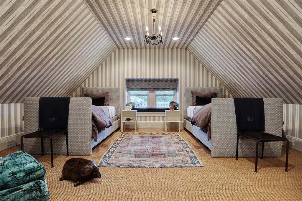 Stripe wallpaper on walls and ceilings of attic bedroom. Luxurious interior design details in a Tudor Revival house renovation in Houston. Design consultant: Pam Pierce. Many reclaimed antique materials from Chateau Domingue. #housetour #oldworld #pampierce #chateaudomingue #europeanantiques #luxurioushome #interiordesignideas #Frenchcountry #limestone #reclaimedflooring #bespoke #houstonhome