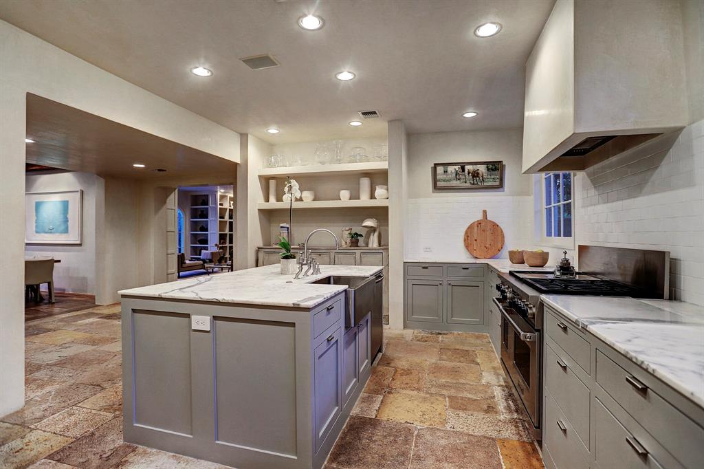 Old World with modern in a kitchen. Luxurious interior design details in a Tudor Revival house renovation in Houston. Design consultant: Pam Pierce. Many reclaimed antique materials from Chateau Domingue. #housetour #oldworld #pampierce #chateaudomingue #europeanantiques #luxurioushome #interiordesignideas #Frenchcountry #limestone #reclaimedflooring #bespoke #houstonhome