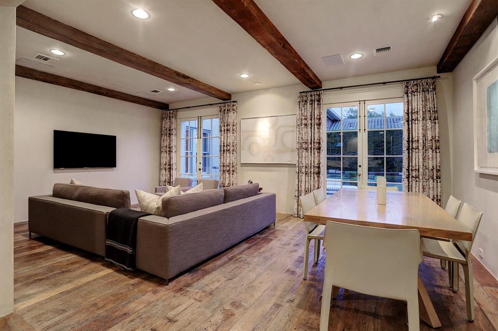 Chestnut floors in a family room. Luxurious interior design details in a Tudor Revival house renovation in Houston. Design consultant: Pam Pierce. Many reclaimed antique materials from Chateau Domingue. #housetour #oldworld #pampierce #chateaudomingue #europeanantiques #luxurioushome #interiordesignideas #Frenchcountry #limestone #reclaimedflooring #bespoke #houstonhome