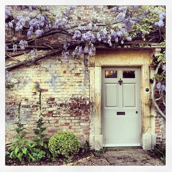 Storybook charm and lovely English country house exterior inspiration describe this lovely cottage exterior and gardens. The Beach Studios. Atlanta Bartlett. #Englishcottage #houseexterior #curbappeal #countryhouse #wisteria #rustic #Europeancountry #Englishcountry #cottagestyle