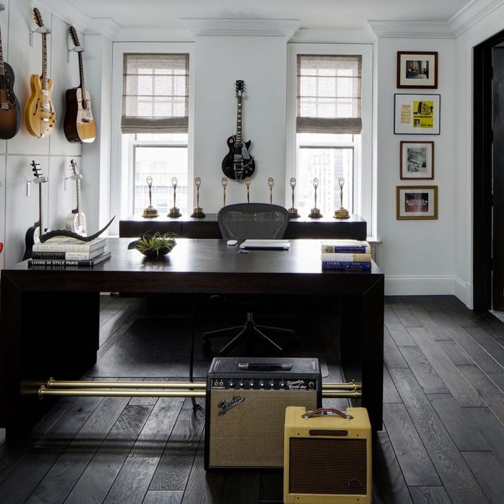 Stylish home office with guitars on wall. Beautiful interior design inspiration from Chicago designer Cari Giannoulias on Hello Lovely Studio. #hellolovelystudio #interiordesign #carigiannoulias #chicagodesigner #interiordesigner #sophisticateddecor #understated #luxurydecor