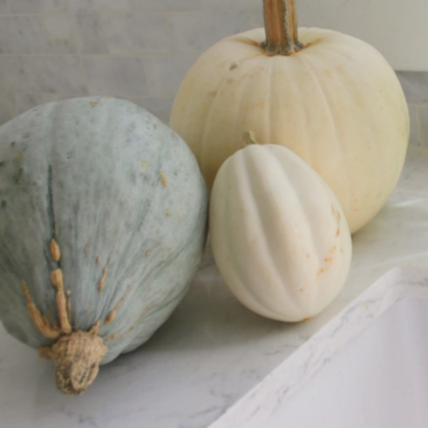 Pastel and white fall decor in my kitchen which has a relaxed, European country and shabby chic vibe. See more of it on my blog Hello Lovely where you'll see my style is serene and peaceful. #hellolovelystudio #falldecor #pastels #serenedecor #whitedecor #europeancountry #farmhousestyle #frenchfarmhouse #pumpkins