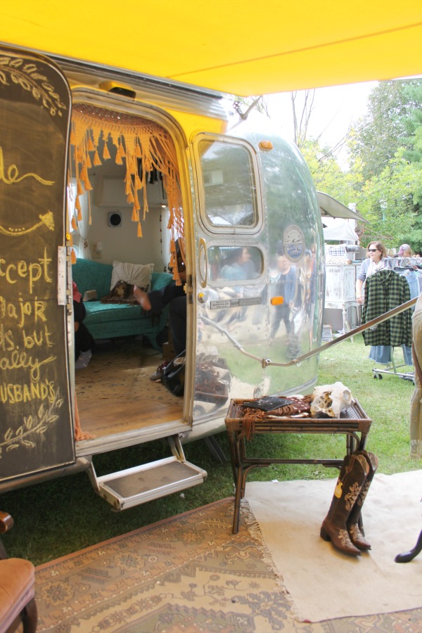 Vintage airstream with bright yellow awning at Main Street Market - Hello Lovely Studio.