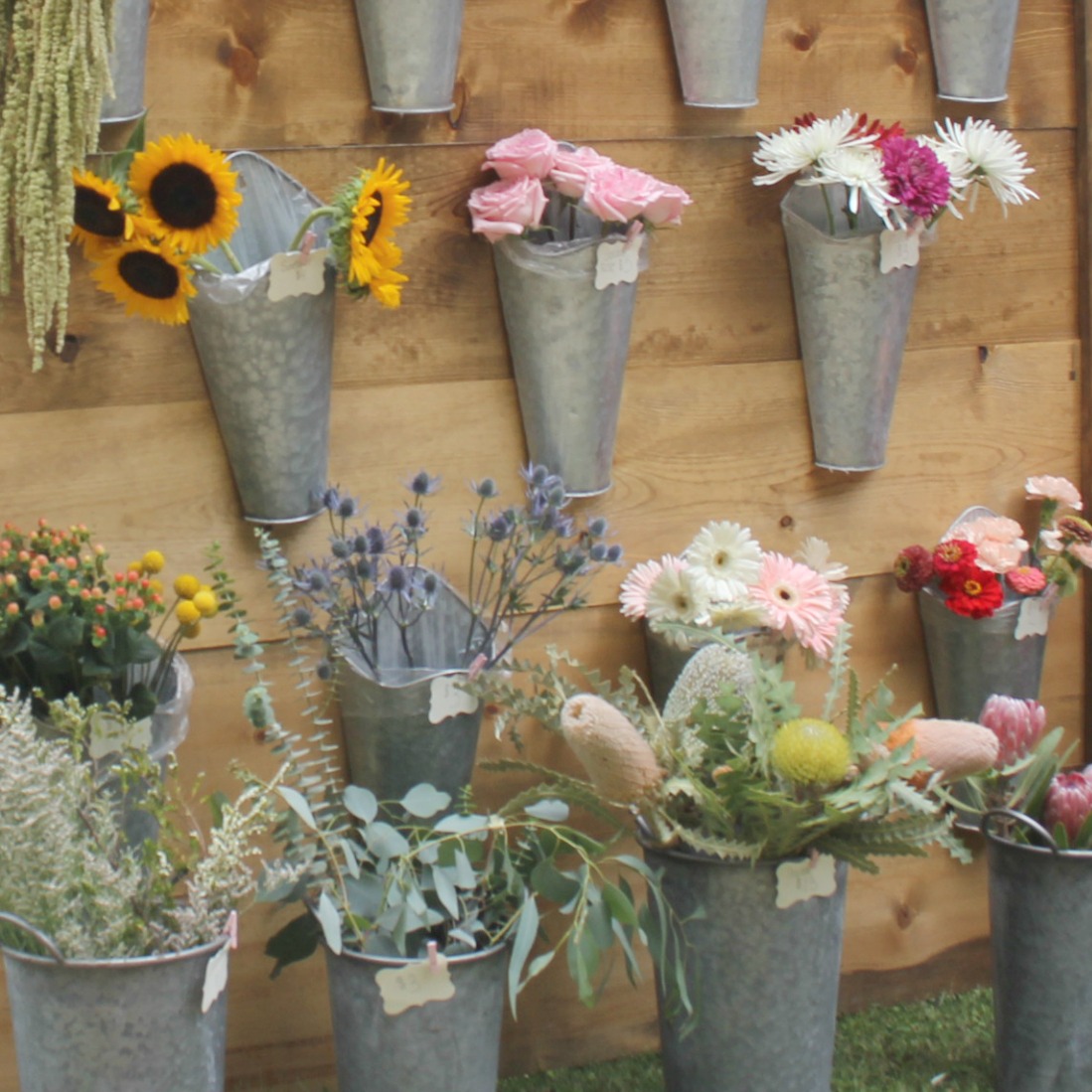 Farmhouse metal buckets of lovely at Evelyn's Acre. So much to love at Main Street Market Rockford in the fall! Hosted by Urban Farmgirl, it draws 150 wonderful vendors from around the country and throngs of shoppers. #hellolovelystudio #mainstreetmarket #rockford #urbanfarmgirl #fleamarket #countrymarket #farmhousedecor #farmhousestyle #midwest #fall