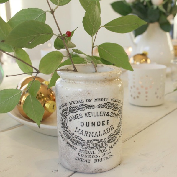 Vintage Dundee marmalade jar used as vase on a white farmhouse Christmas table - Hello Lovely Studio. #dundeemarmalade #vintagecrocks #frenchfarmhouse #farmhousechristmas #christmasdecor #christmastable