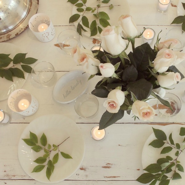 White romantictablescape with candlelight and blush roses. Hello Lovely Studio.