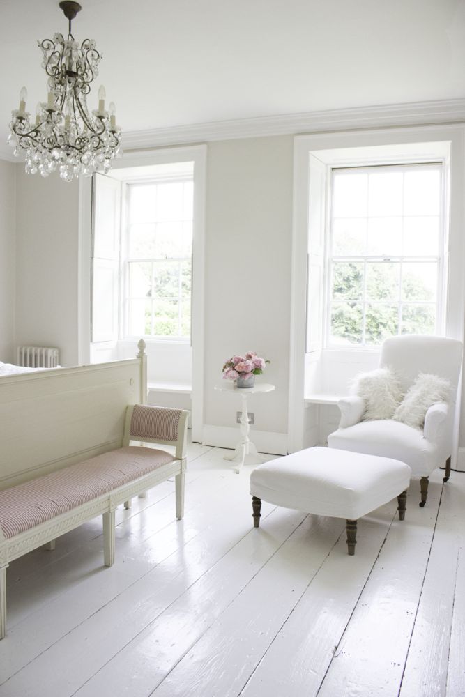 Multiple shades of white mix for a glorious cloud-like interior. Scandinavian style white Nordic French design details as well as spare decor style meet English countryside charm in "The Hatch," a photographic location in Wiltshire. Design: Atlanta Bartlett & Dave Coote of the Beach Studios. #livingroom #scandinavian #interiordesign #whitedecor #frenchnordic #nordicFrench #Swedishstyle #serene #shabbychic