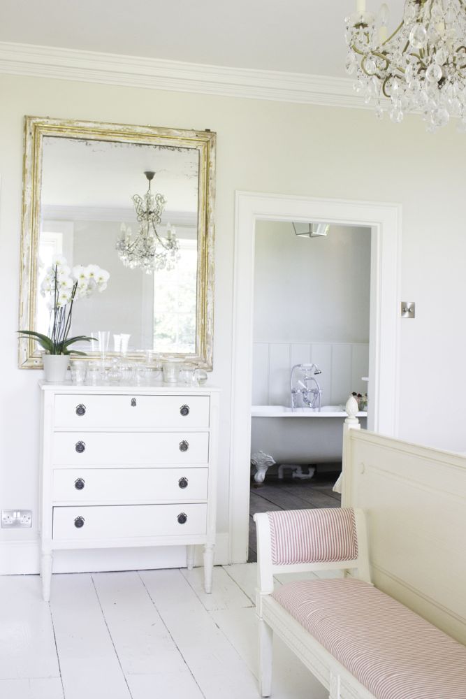 Multiple shades of white mix for a glorious cloud-like interior. Scandinavian style white Nordic French design details as well as spare decor style meet English countryside charm in "The Hatch," a photographic location in Wiltshire. Design: Atlanta Bartlett & Dave Coote of the Beach Studios. #livingroom #scandinavian #interiordesign #whitedecor #frenchnordic #nordicFrench #Swedishstyle #serene #shabbychic